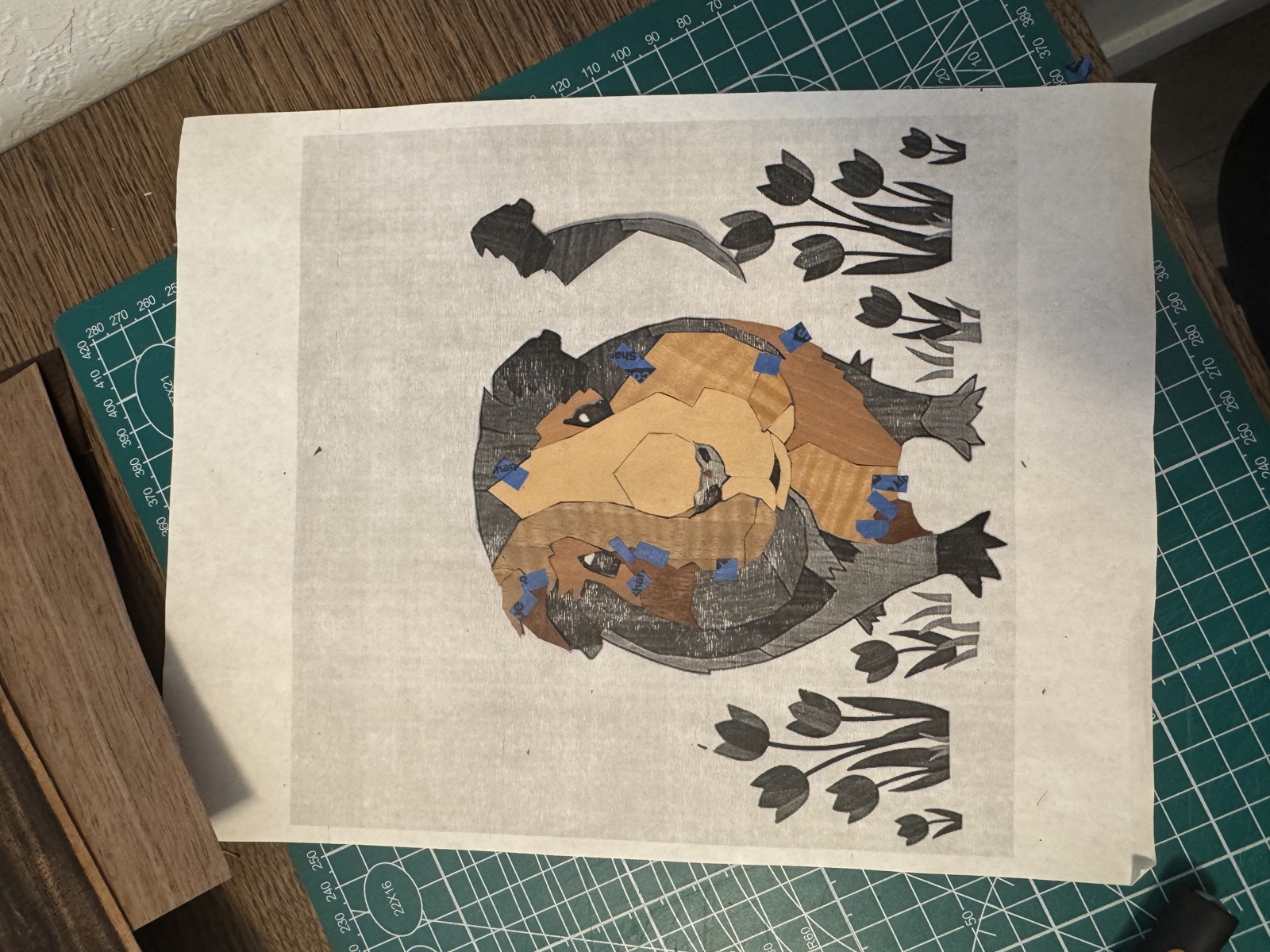 Early veneer pieces for the guinea pig taped onto the printed pattern