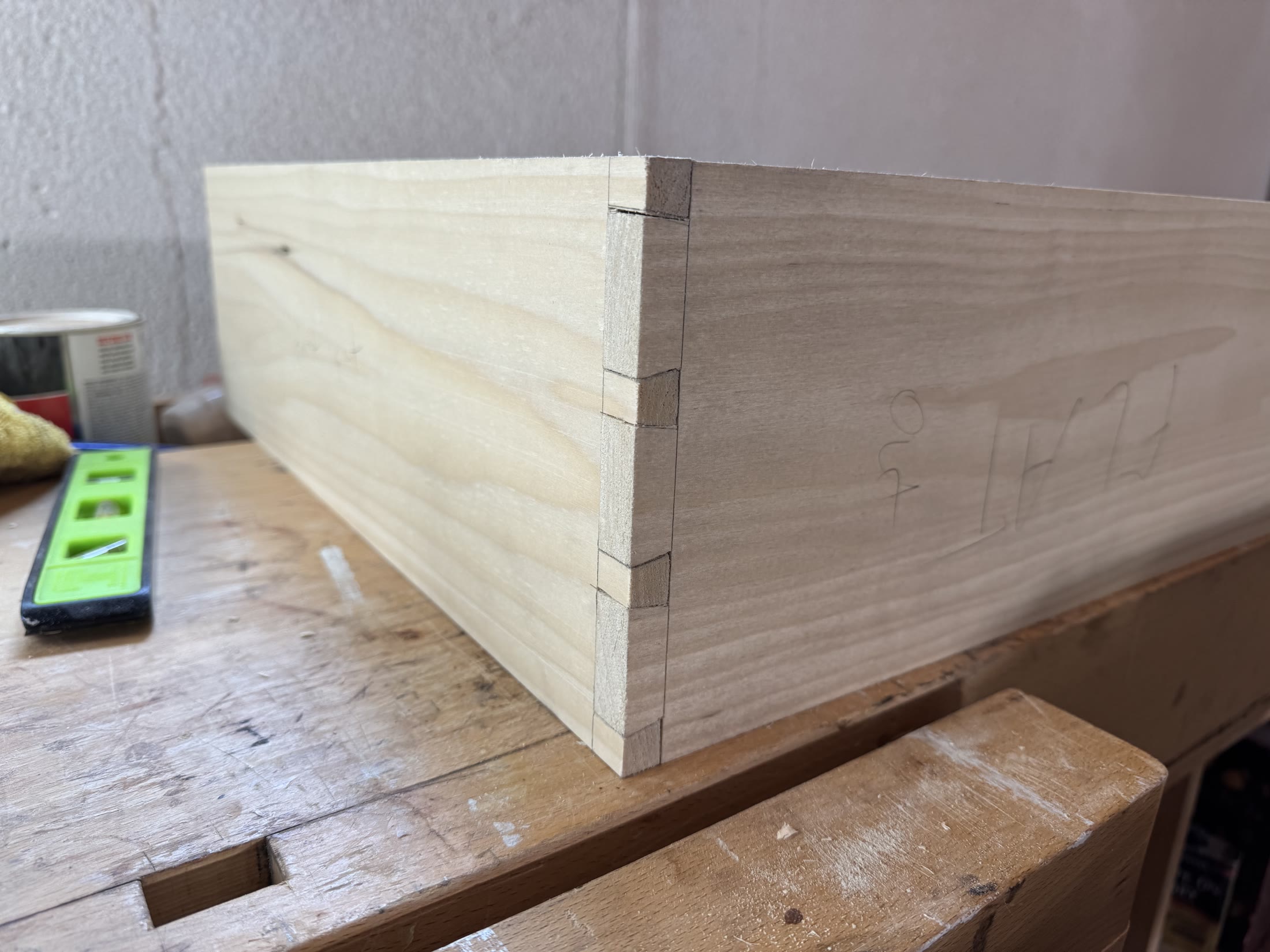 Close view of hand-cut through dovetails at the corner of a drawer box