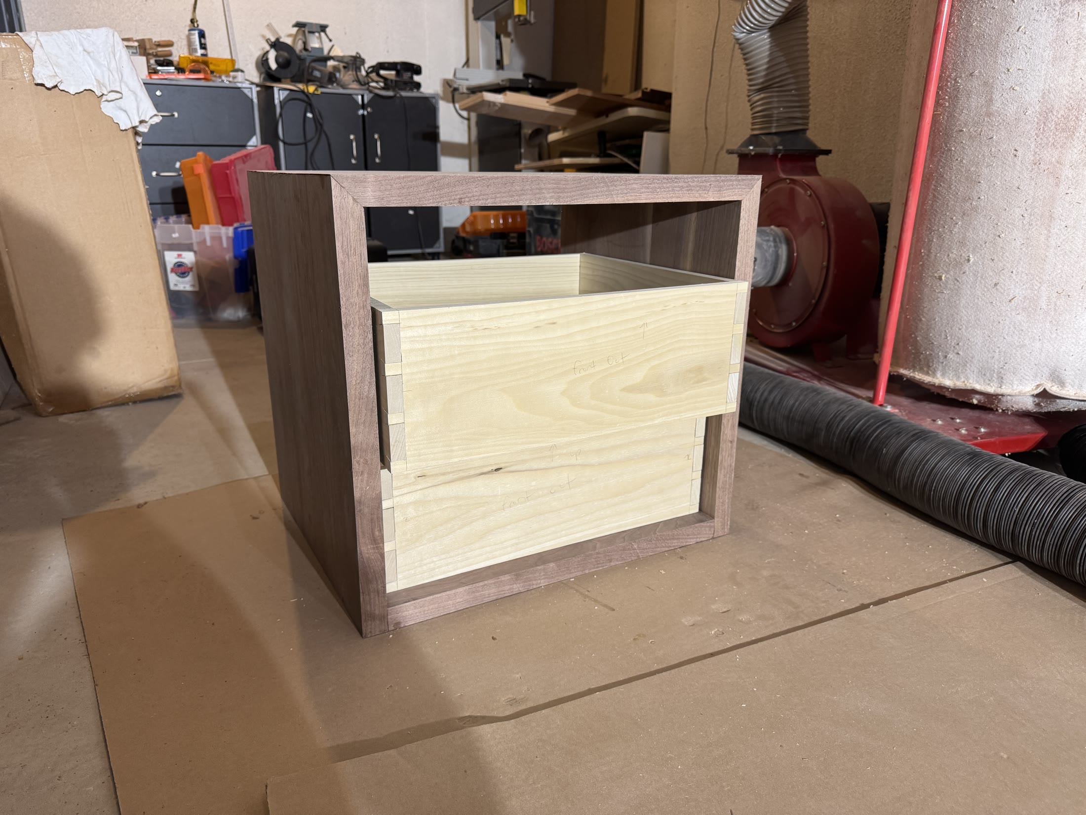 A drawer being fit into the walnut carcass