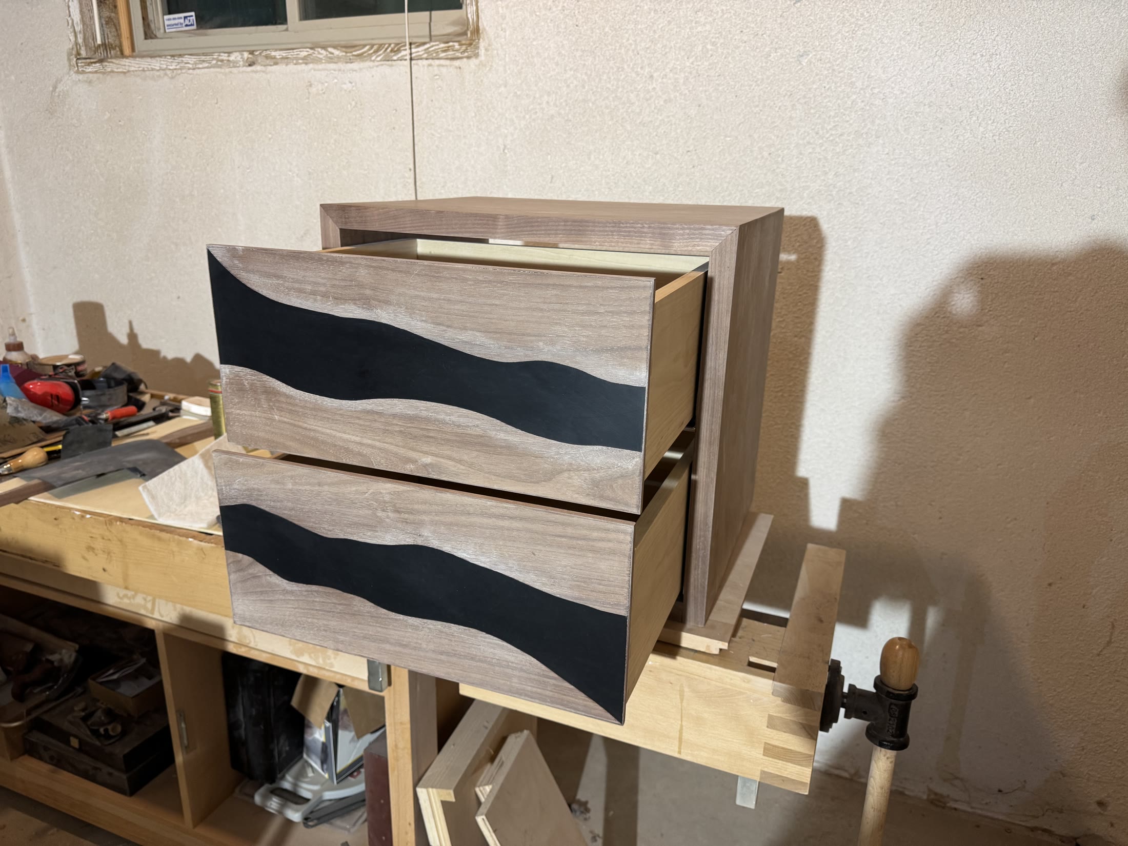 Both drawers pulled open, showing the wave carrying across the fronts