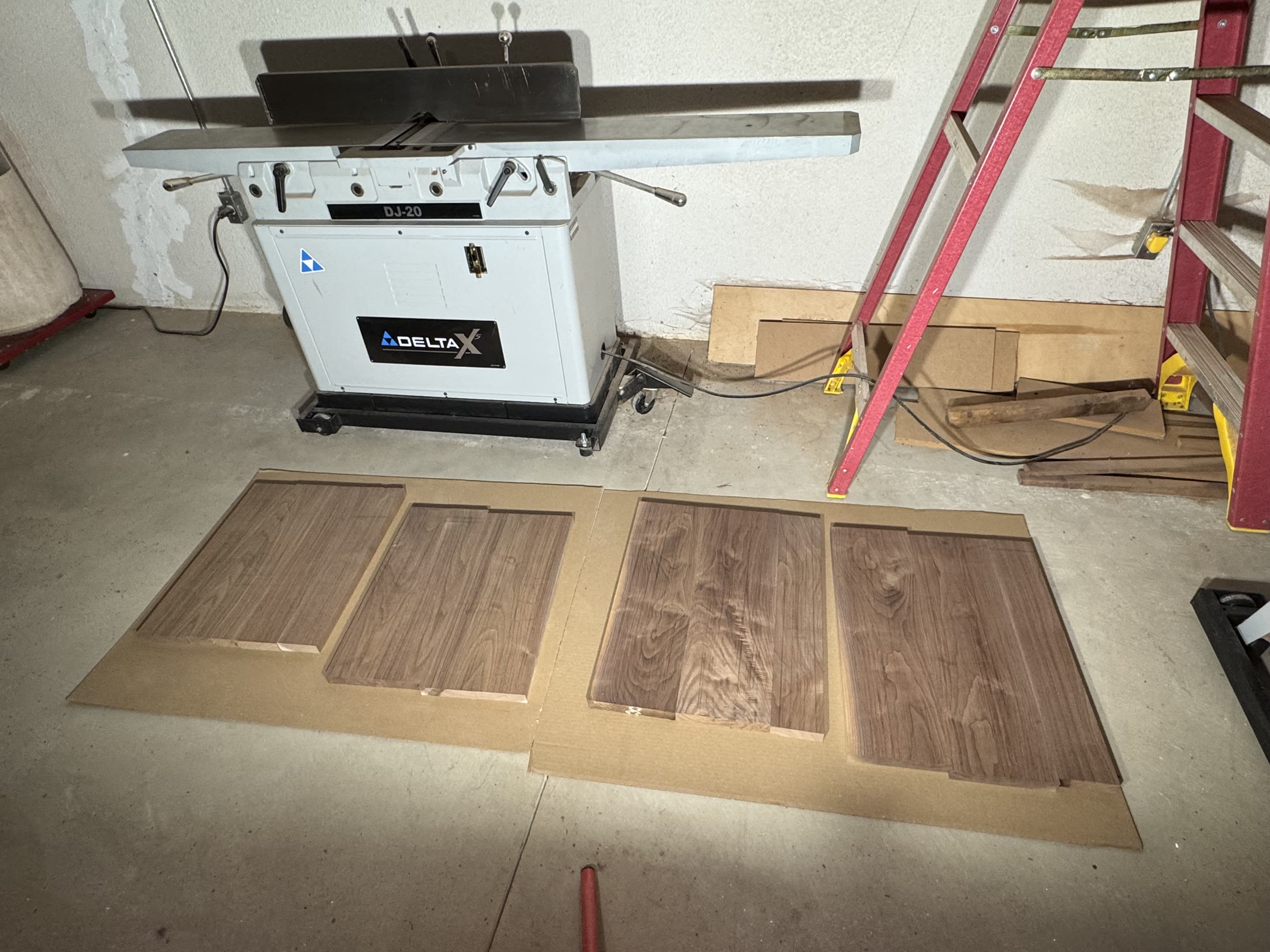 Milled walnut panels laid out on the shop floor