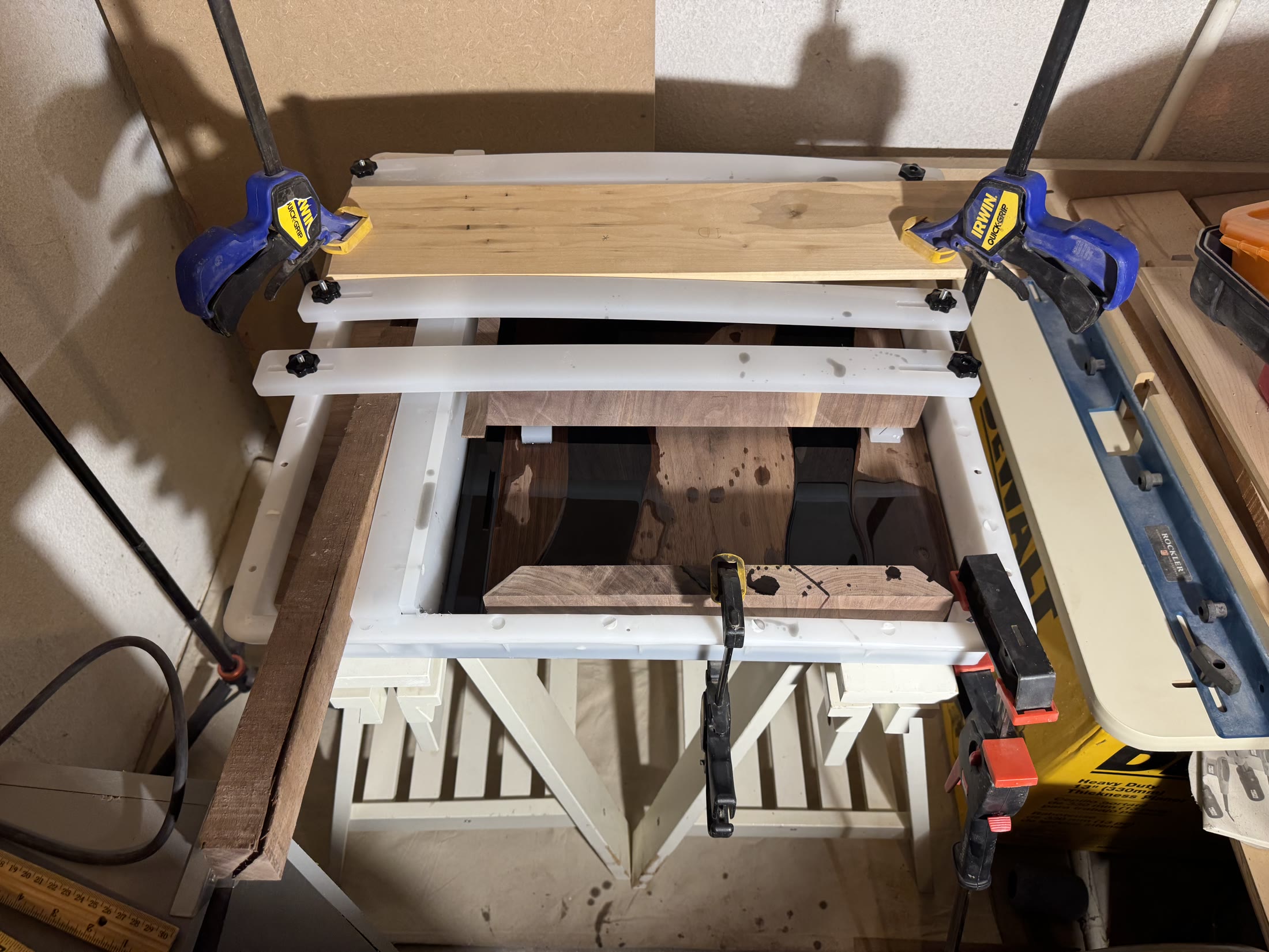 Black epoxy poured into the mold around the clamped walnut