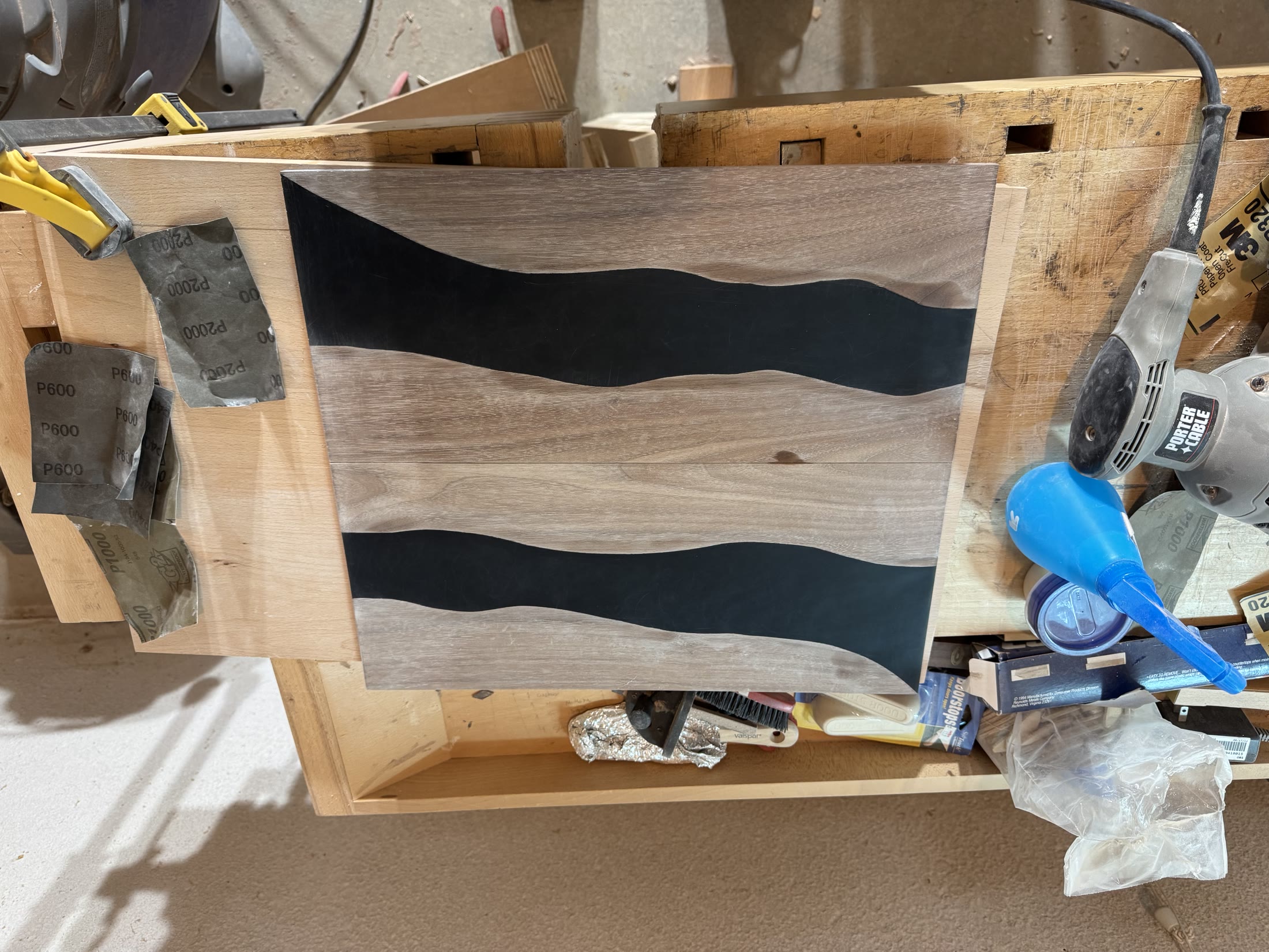 Close view of the black epoxy river running through a walnut drawer front