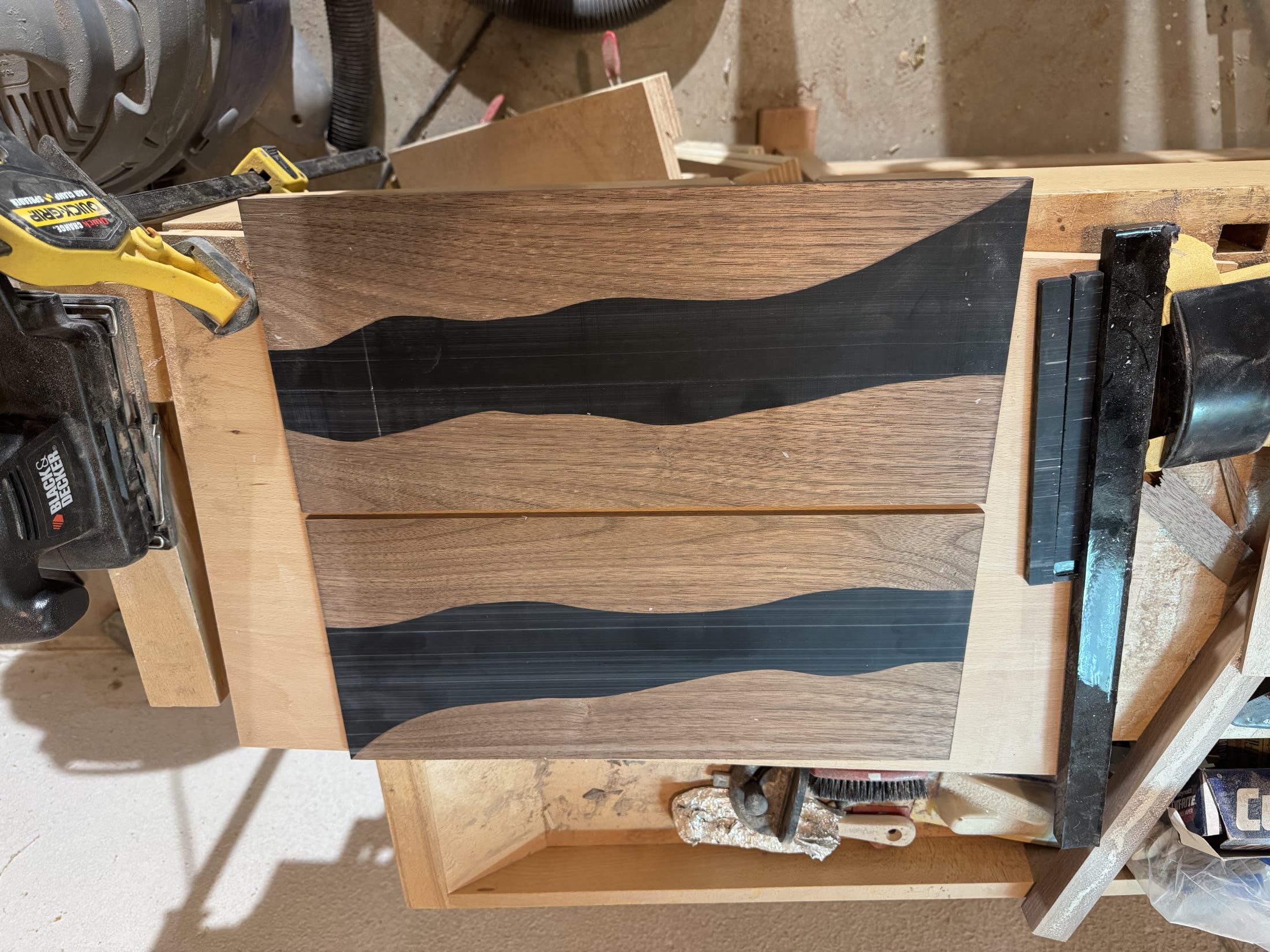 Two drawer-front panels with the black epoxy river sanded flush
