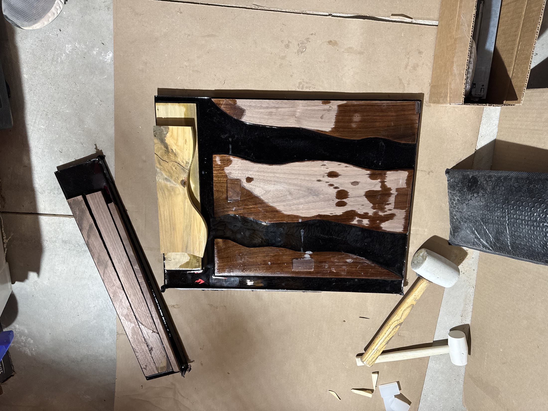 The cured epoxy river panel, glossy and rough before sanding
